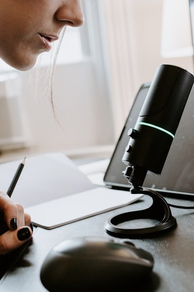 person holding black and green portable speaker