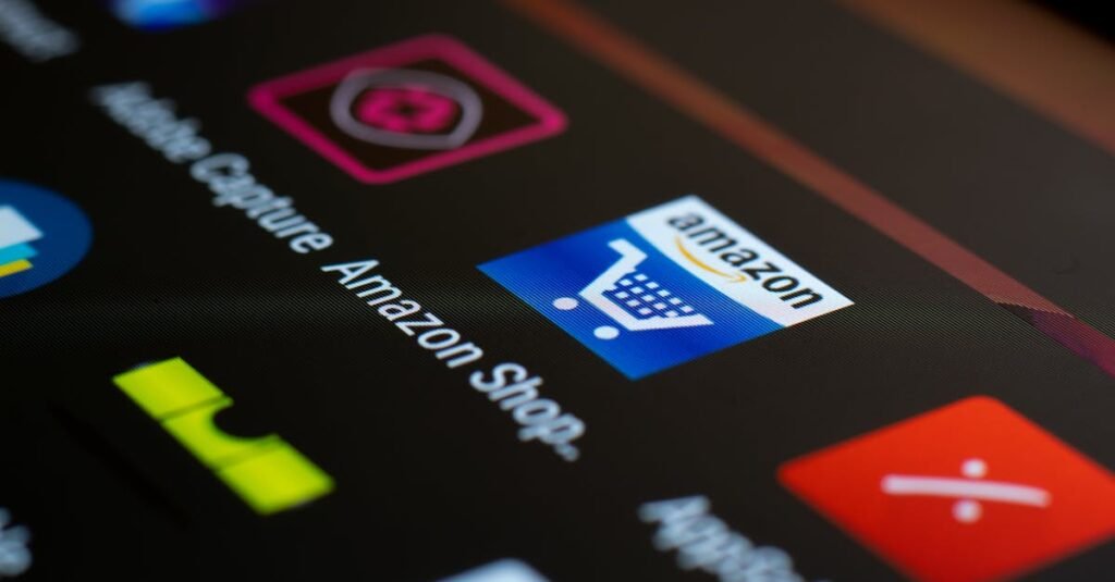 Close-up of the Amazon shopping app icon on a smartphone screen. Ideal for online shopping and technology themes.